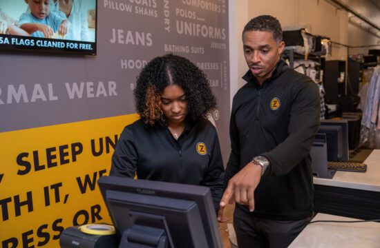 Two ZIPS employees look at a computer