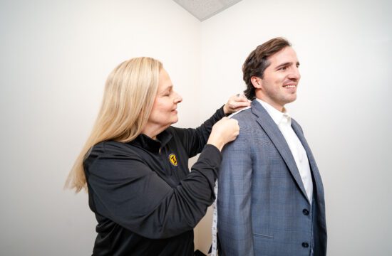 a ZIPS tailor measures a jacket