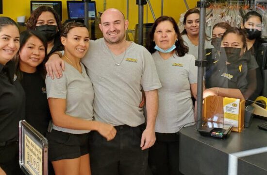 ZIPS owners posing with their employees inside a ZIPS location