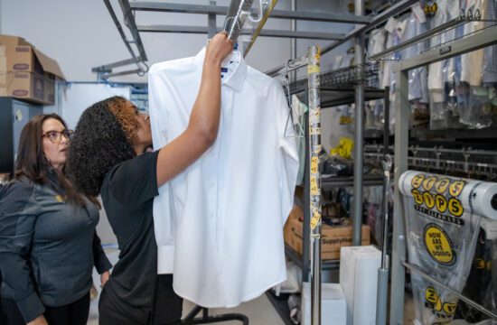 A ZIPS employee hangs up a shirt