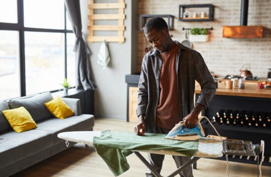 A man ironing clothes.