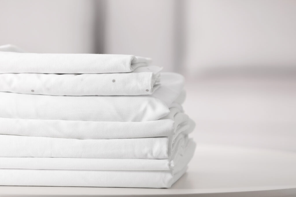 Clean stack of folded bed sheet linens